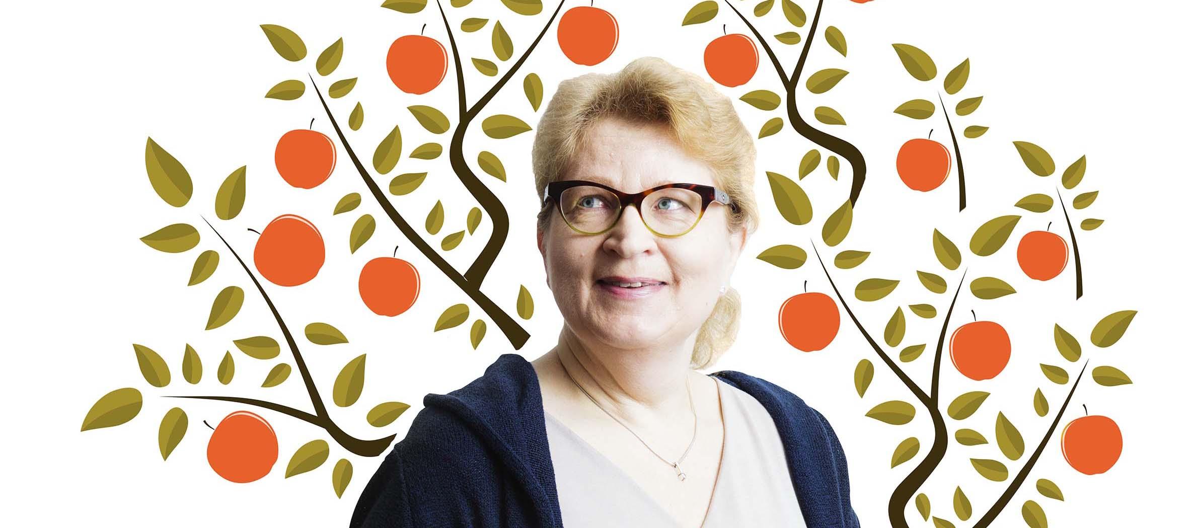 Silmälasipäinen vaalea nainen hymyilee vasempaan yläviistoon, taustalla piirretty omenapuu punaisine omenoineen.